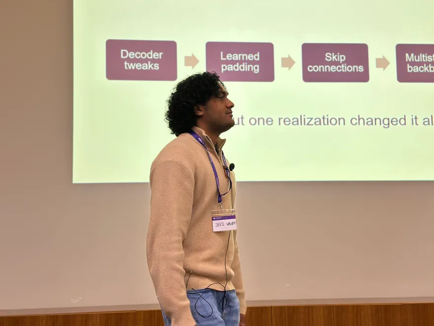 Jevi Waugh presenting frequency-domain segmentation work at the 2026 UQ Summer Research Program showcase